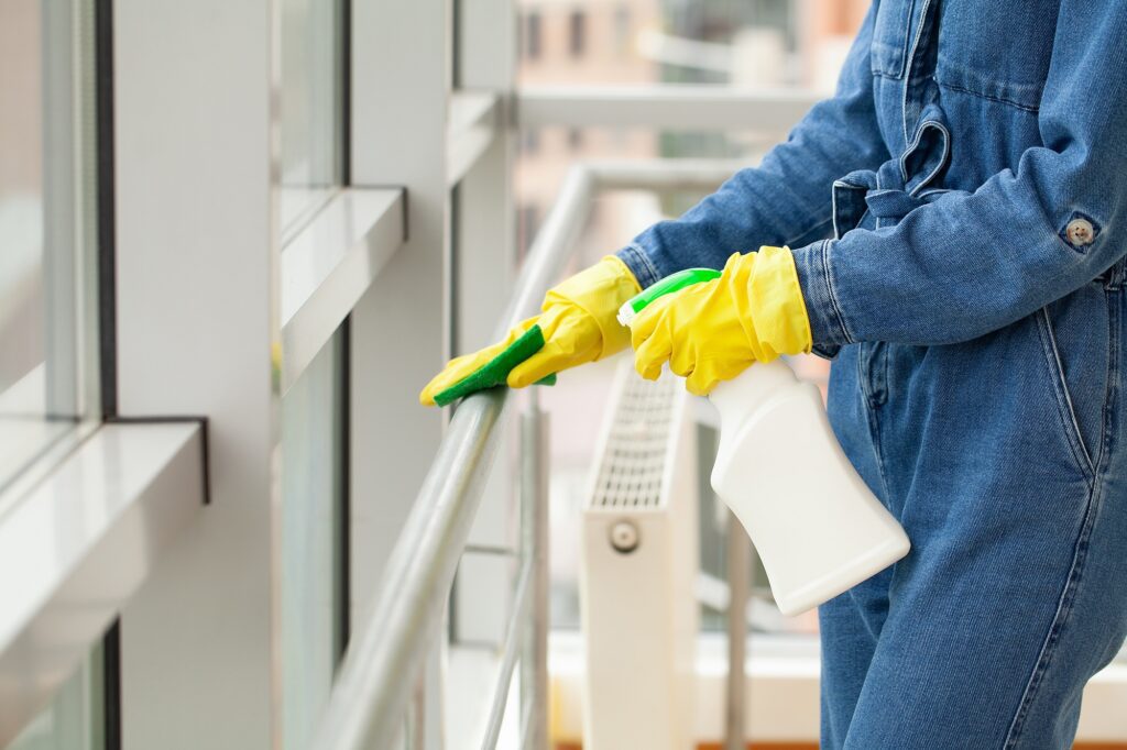 Cleaning concept, young woman with supplies cleaning office
