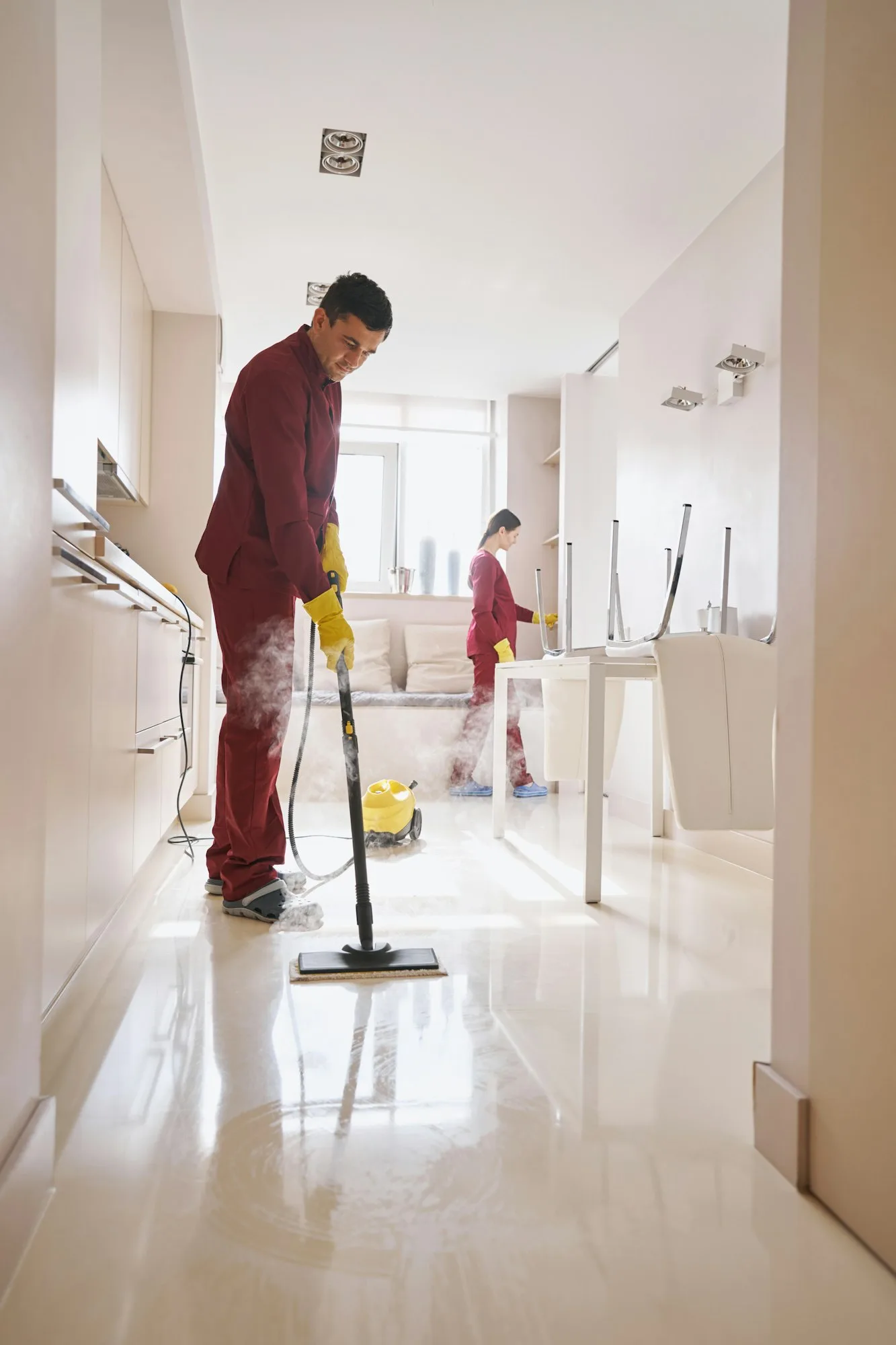 Professional janitorial staff doing cleaning in kitchen